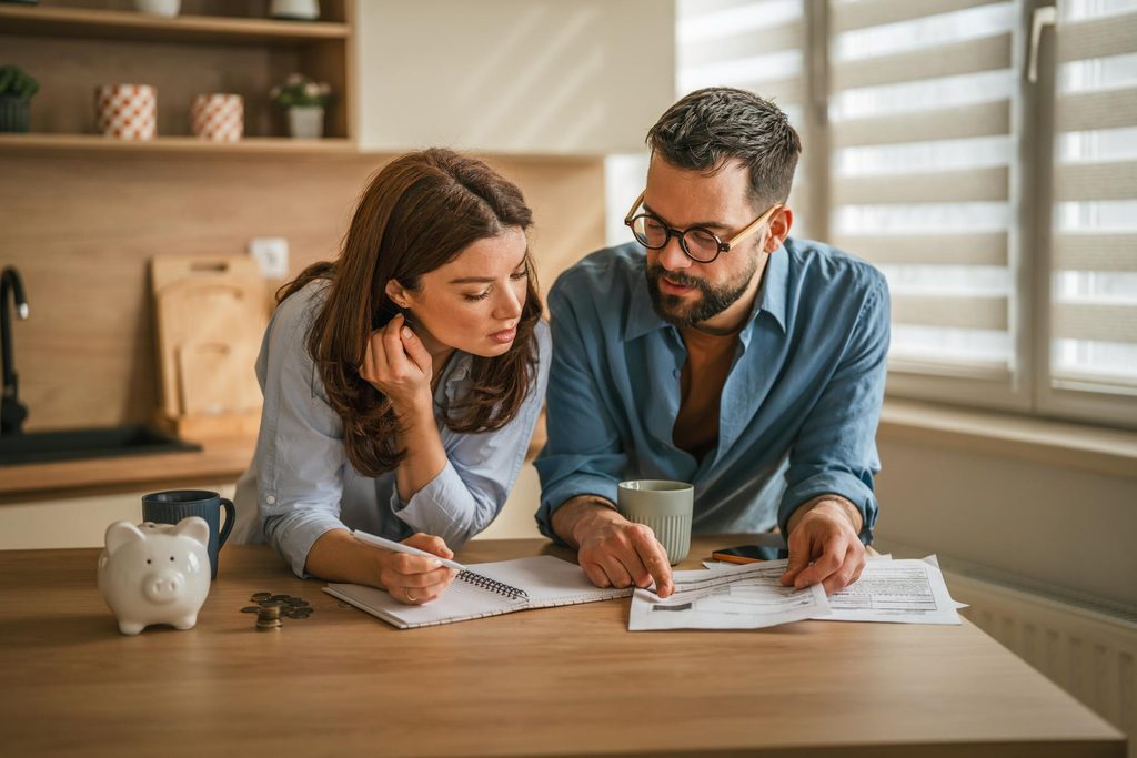Couple reviewing their finances and planning toward long-term financial goals