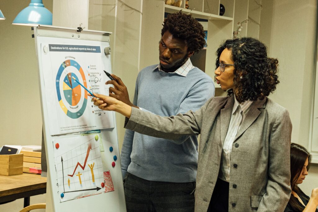 Colleagues engage in data analysis discussion during a team meeting in a contemporary office space.